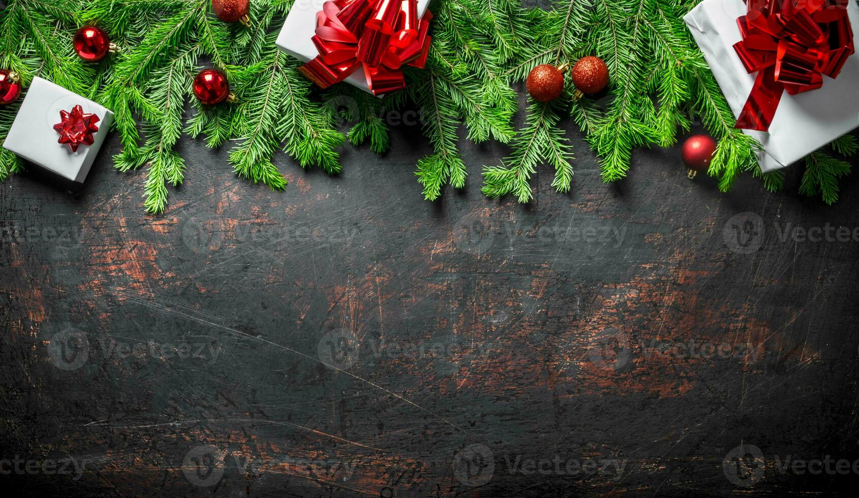 Gift boxes with Christmas decorations and fir branches. photo