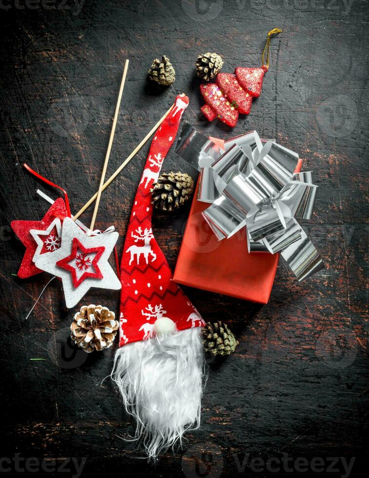 Red gift box with Christmas decorations and cones. photo
