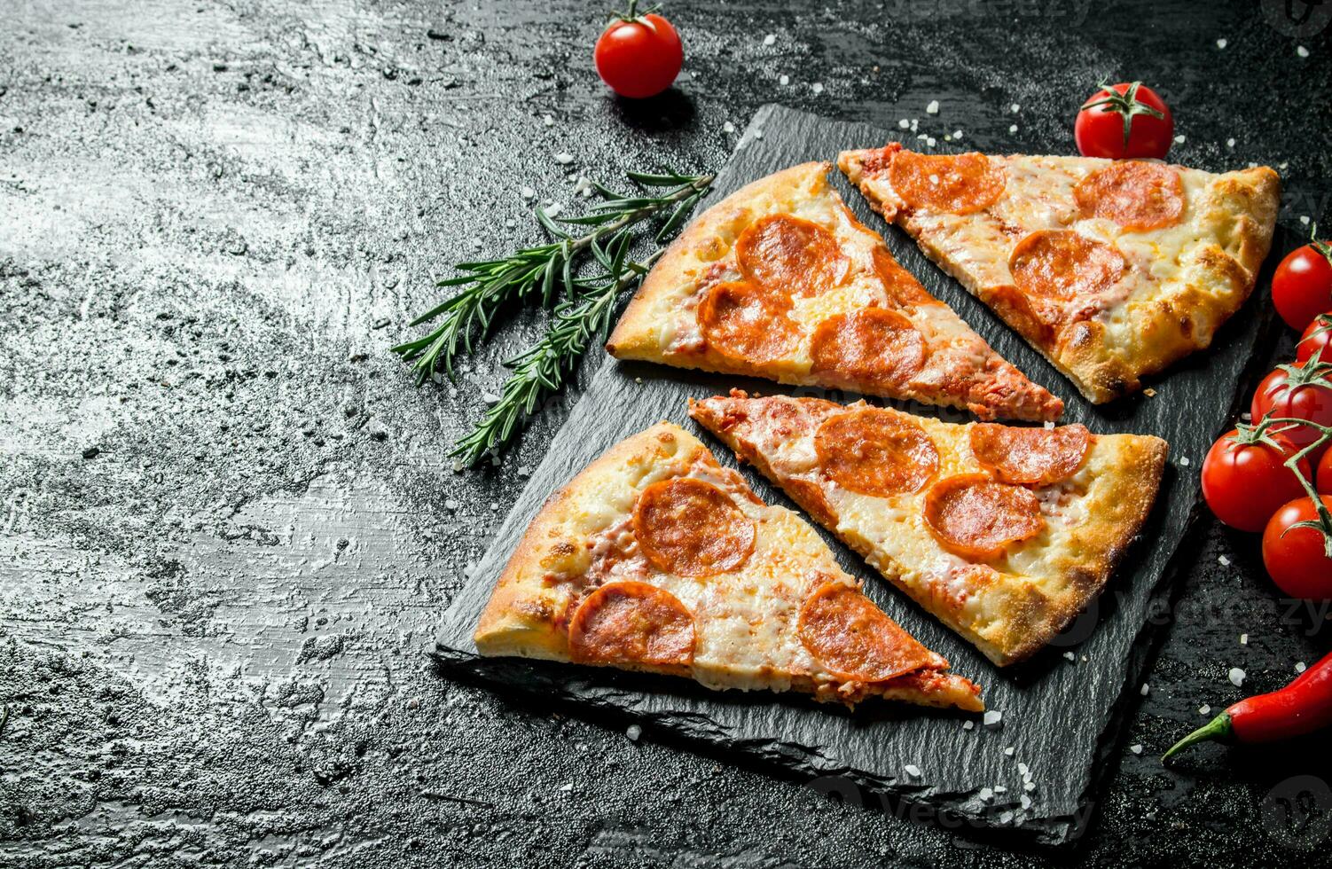 Slices of fragrant pepperoni pizza on a stone Board. 32017141 Stock Photo at Vecteezy
