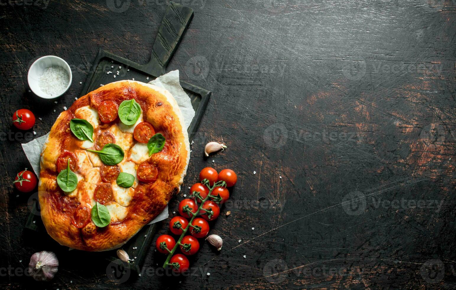Homemade pizza with spices, tomatoes and garlic. photo
