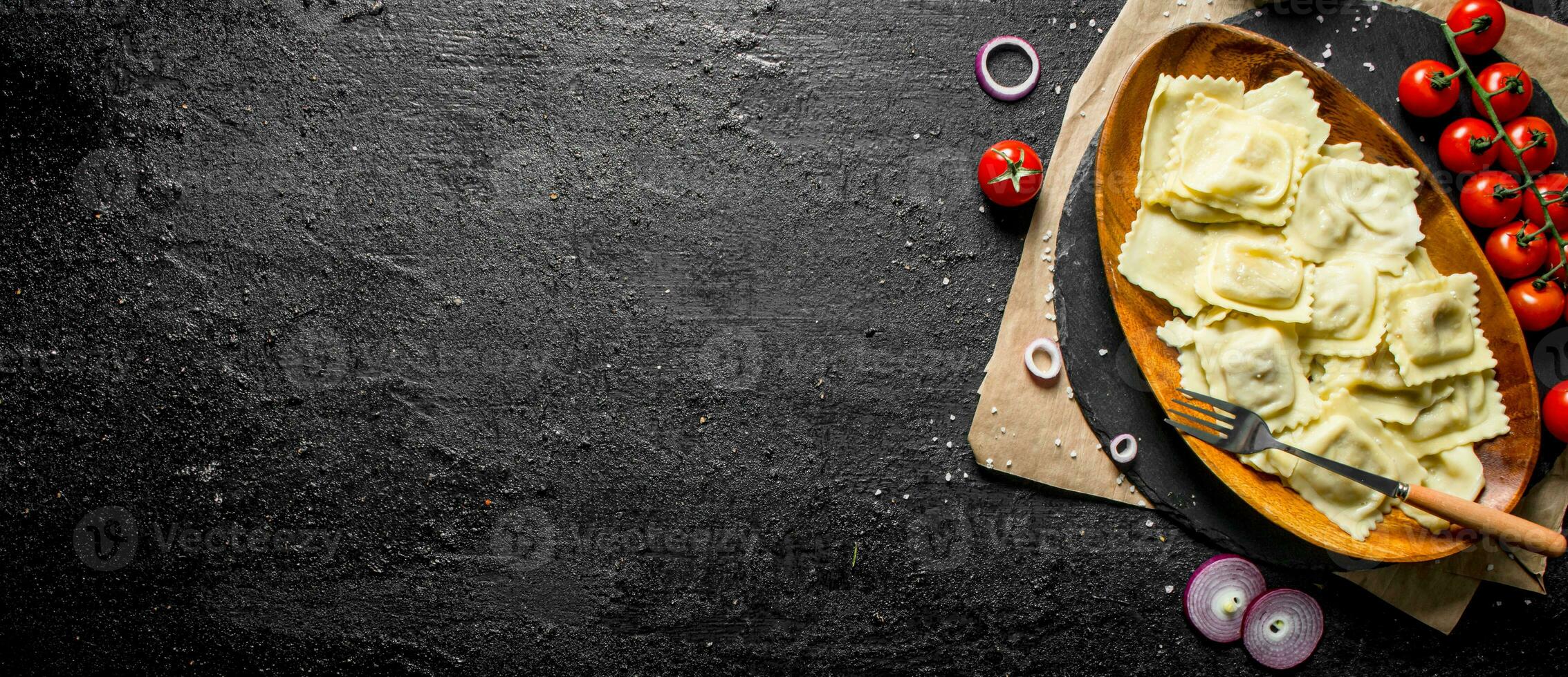 Ravioli with tomatoes, sauce and onion rings. photo