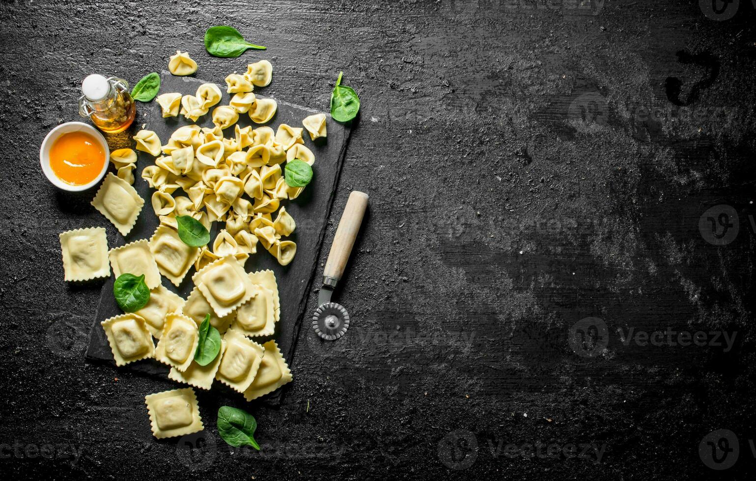 Different kinds of Italian raw pasta with sauce and spinach. photo