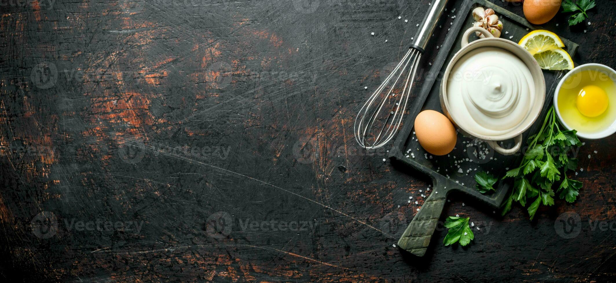 Mayonnaise with eggs, parsley and garlic cloves. photo