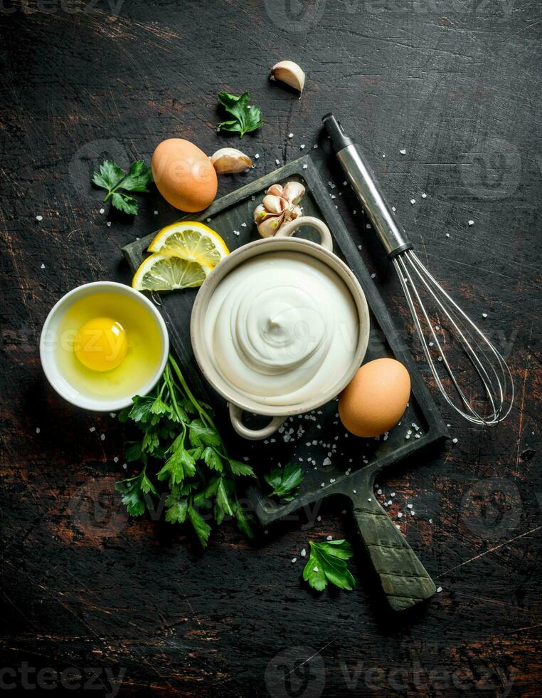 Mayonnaise with eggs, parsley and garlic cloves. photo