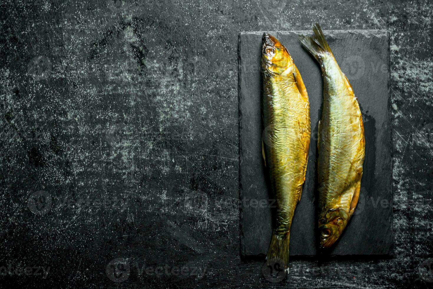 Smoked fish on a stone Board. photo
