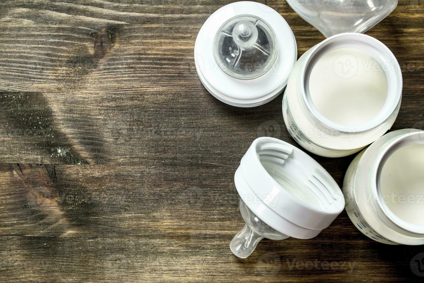 Baby food. Baby milk in small bottles. photo