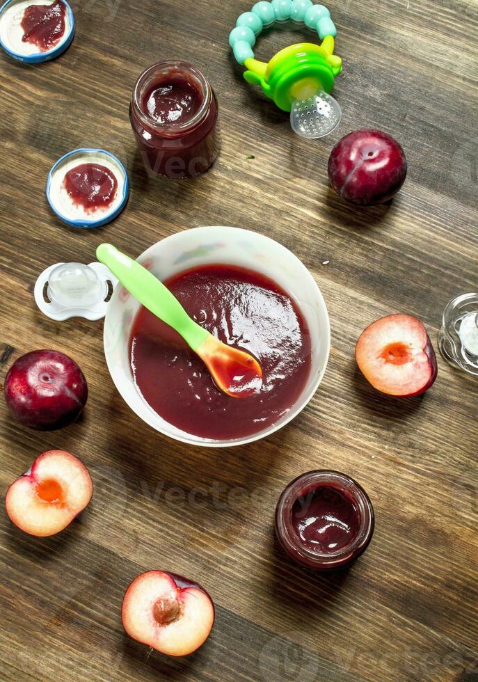 Baby food. Baby puree from fresh plums. photo