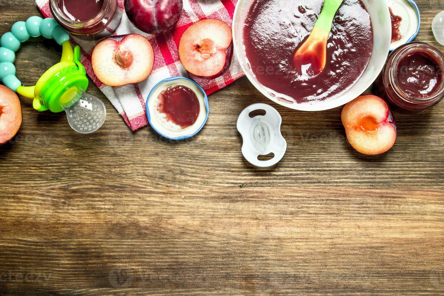 Baby food. Baby puree from fresh plums. photo