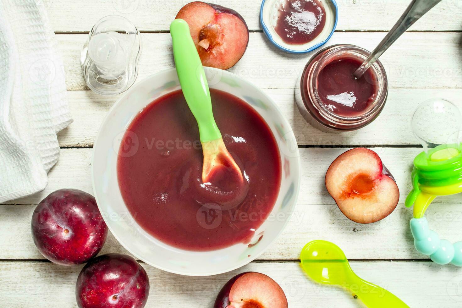 Baby food. Baby puree from fresh plum. photo