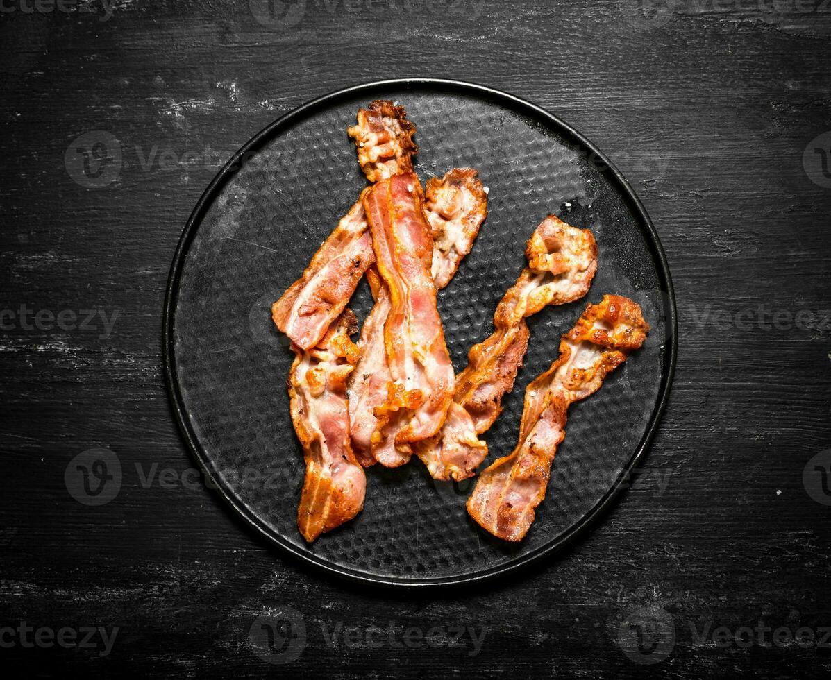Fried bacon on a plate. photo