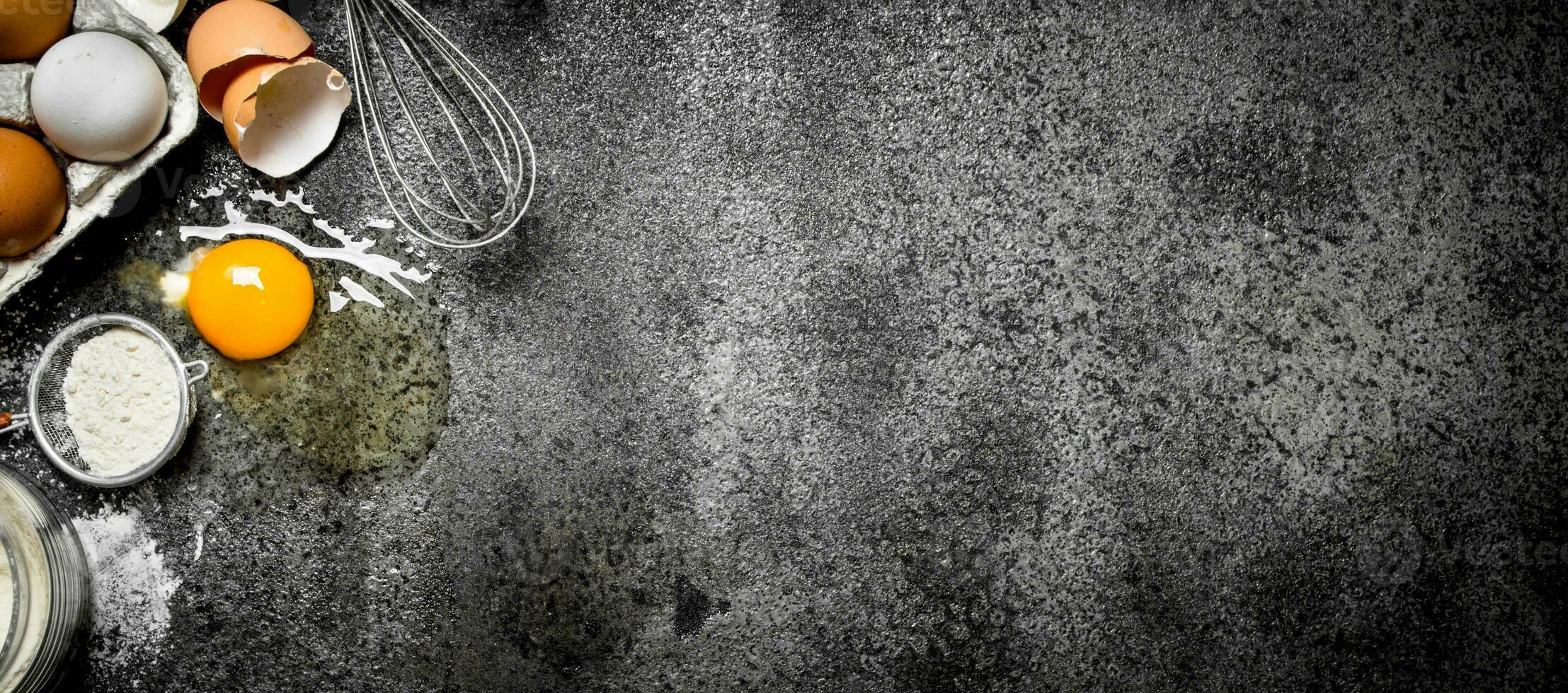 Baking background.Fresh eggs from the scattered flour. photo