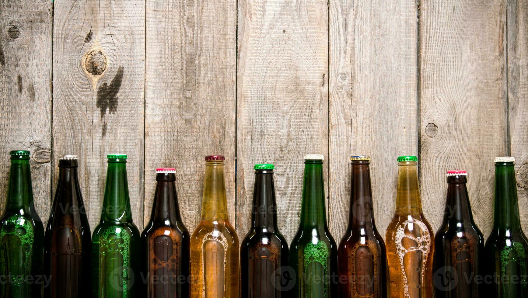 Beer bottles on wooden table . photo