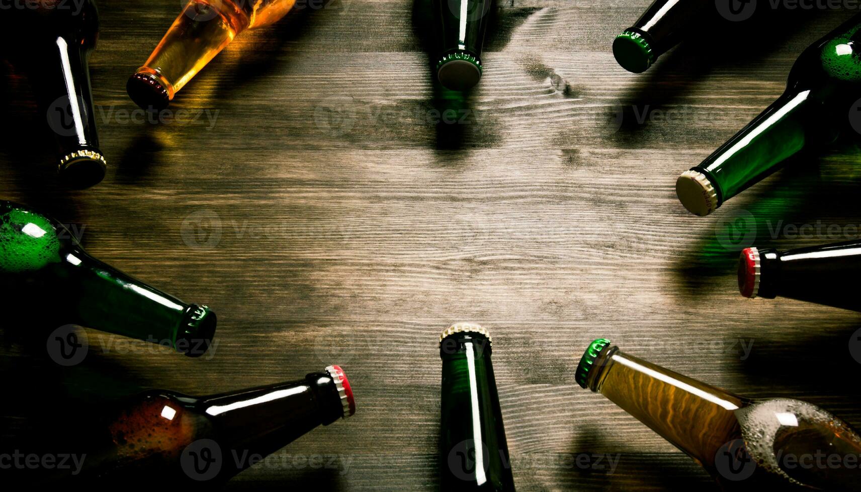 Beer bottles on wooden table . photo