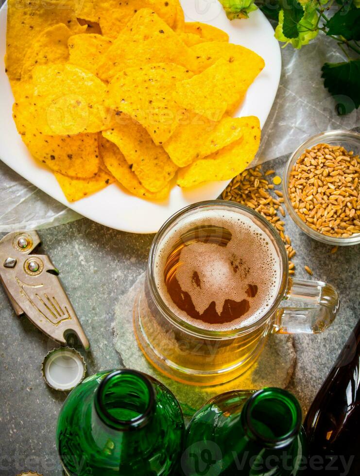 Beer with chips . On old stone background. photo