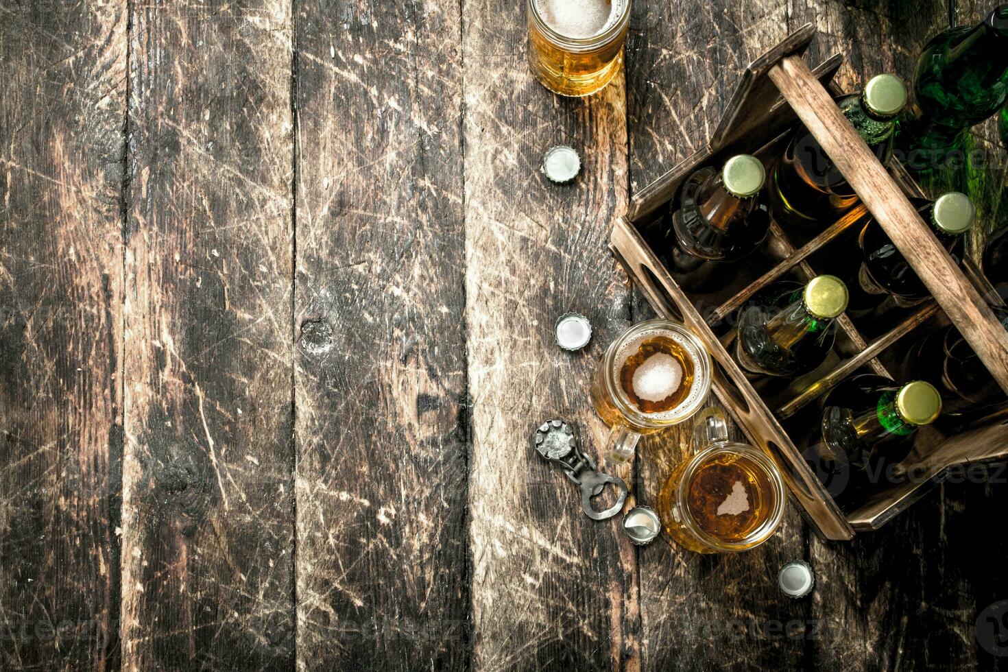 Bottles with beer in an old box. photo