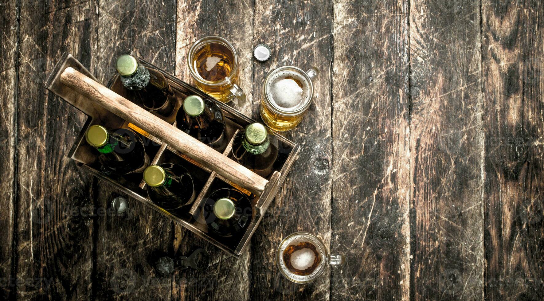 Bottles with beer in an old box. photo