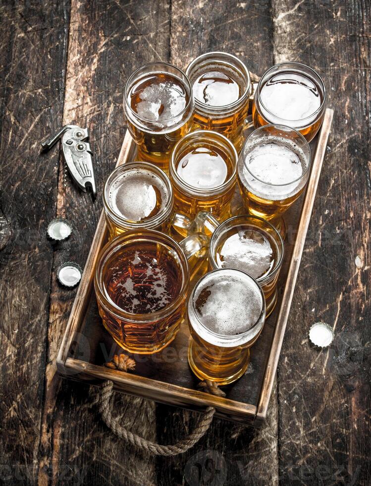 Glasses with fresh beer on an old tray. photo