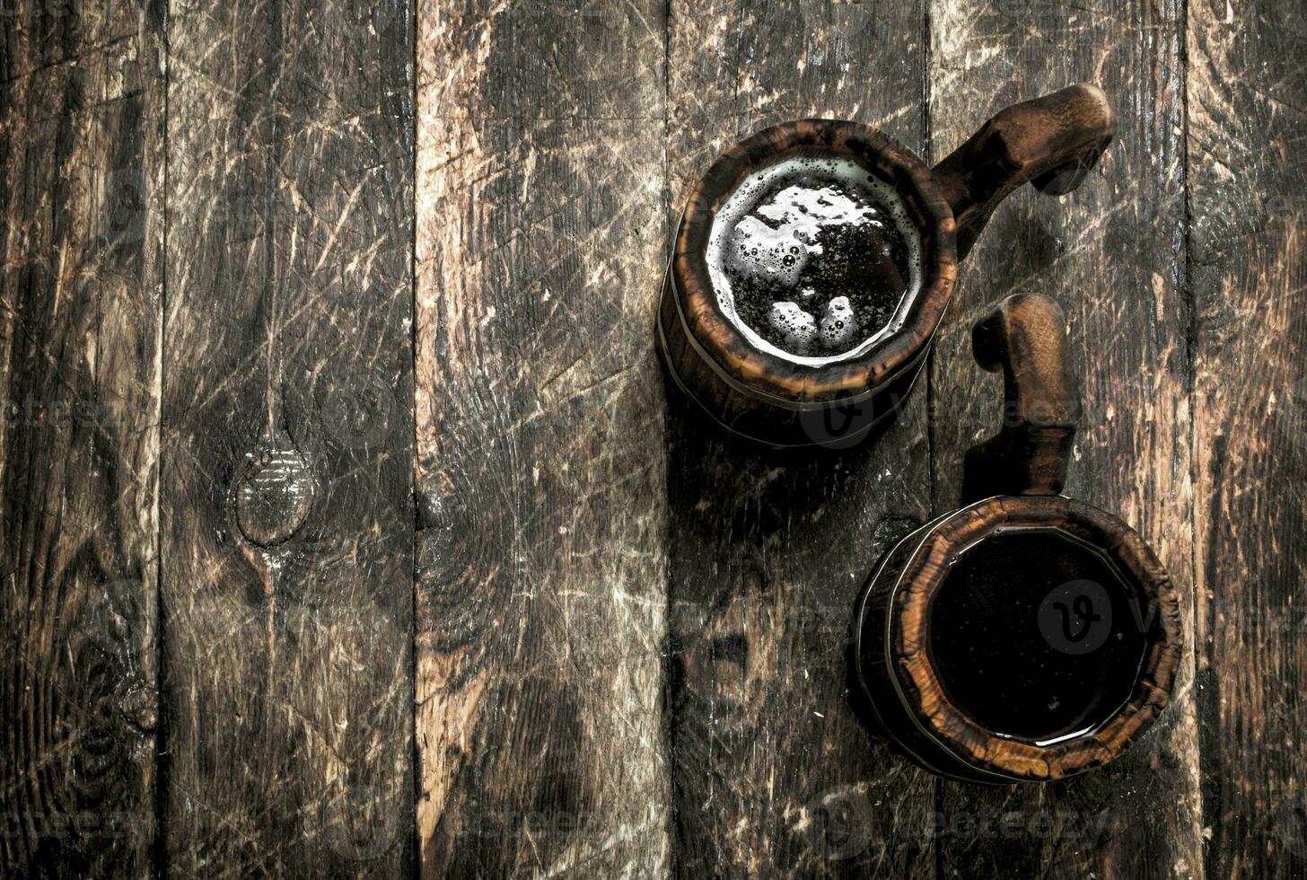 Fresh beer in a wooden mug. photo