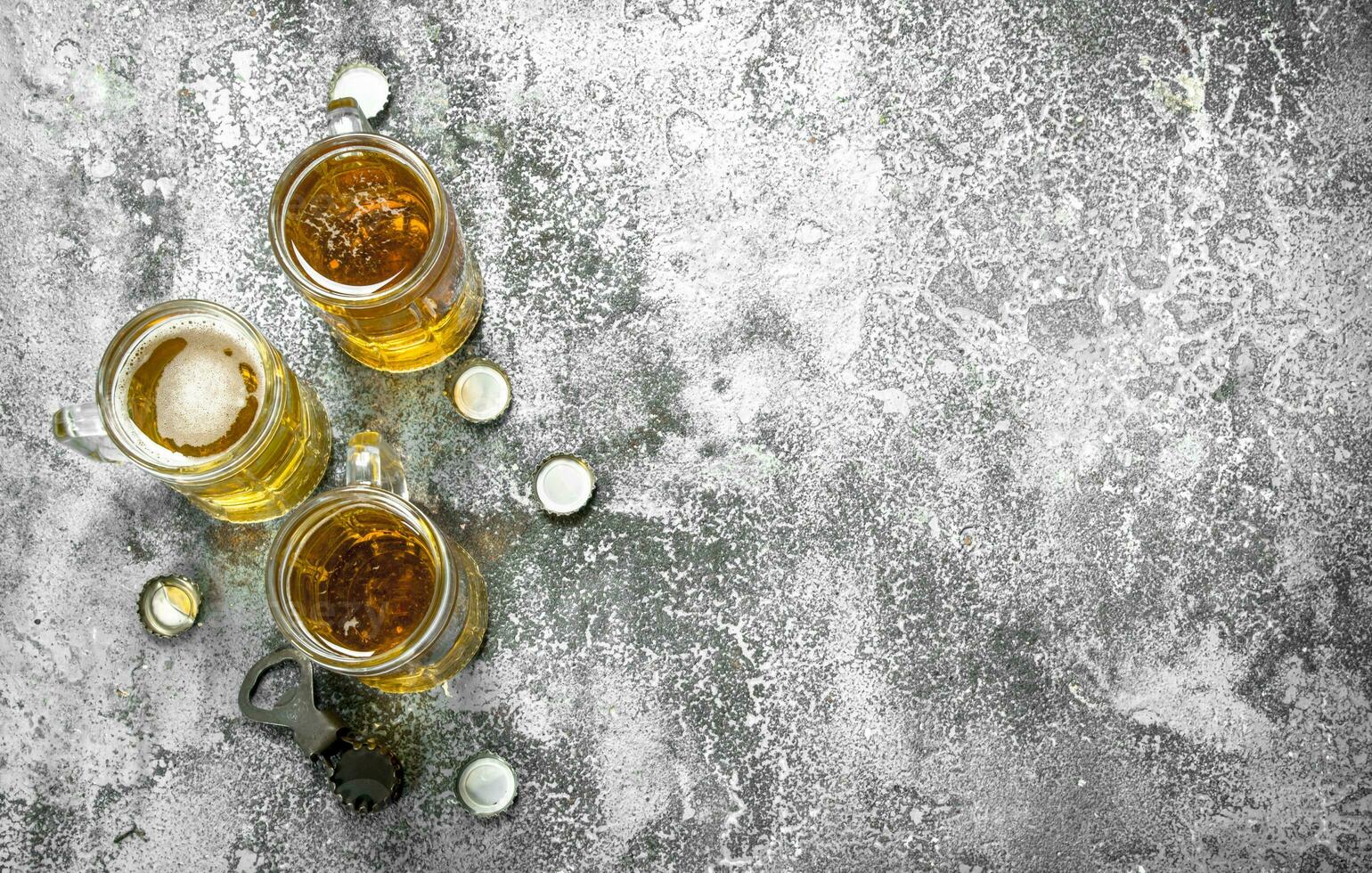 lentes de cerveza con un botella abrelatas y tapones foto