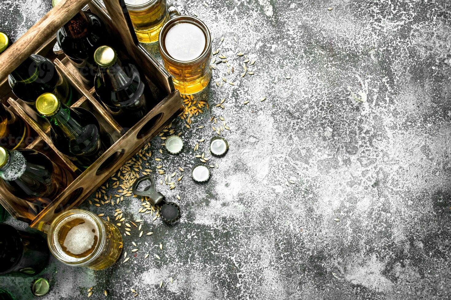 Beer background. Fresh beer in glasses and an old box. photo