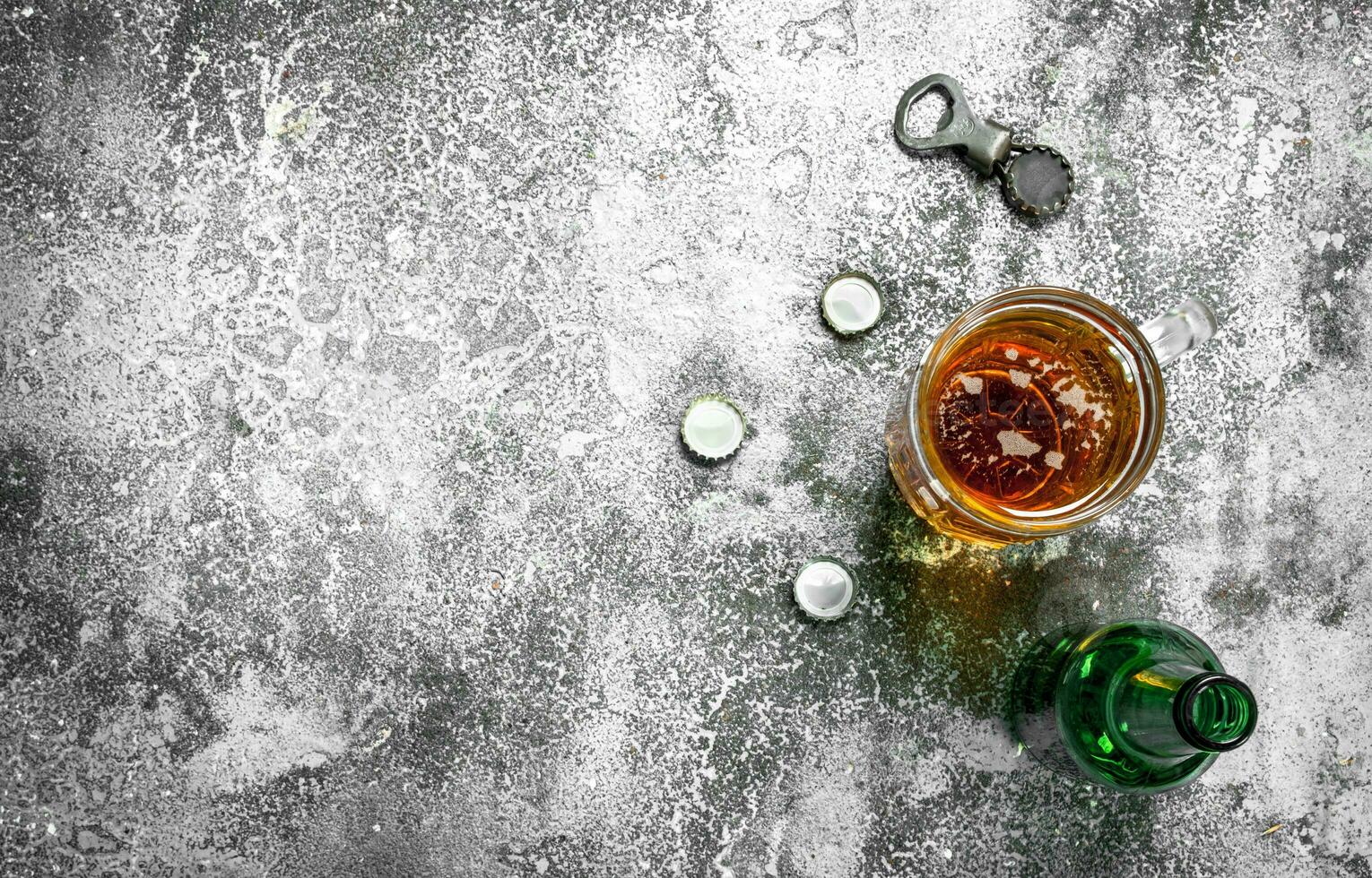 glass of beer with a bottle opener and stoppers. photo