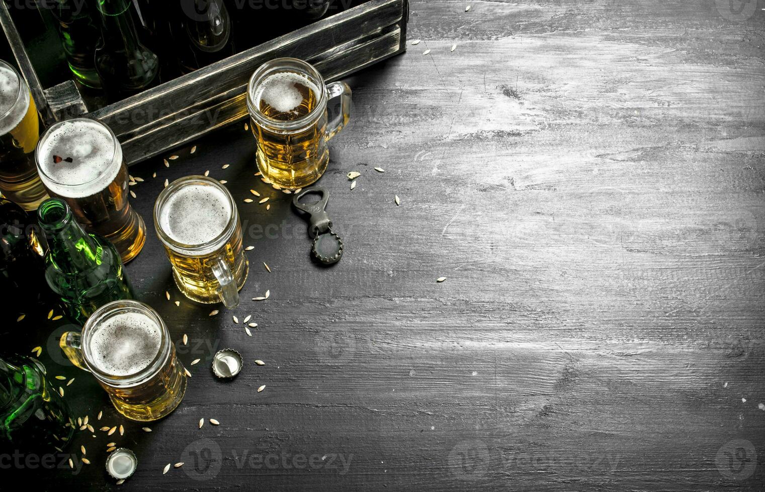 Fresh beer in glasses and in an old box. photo