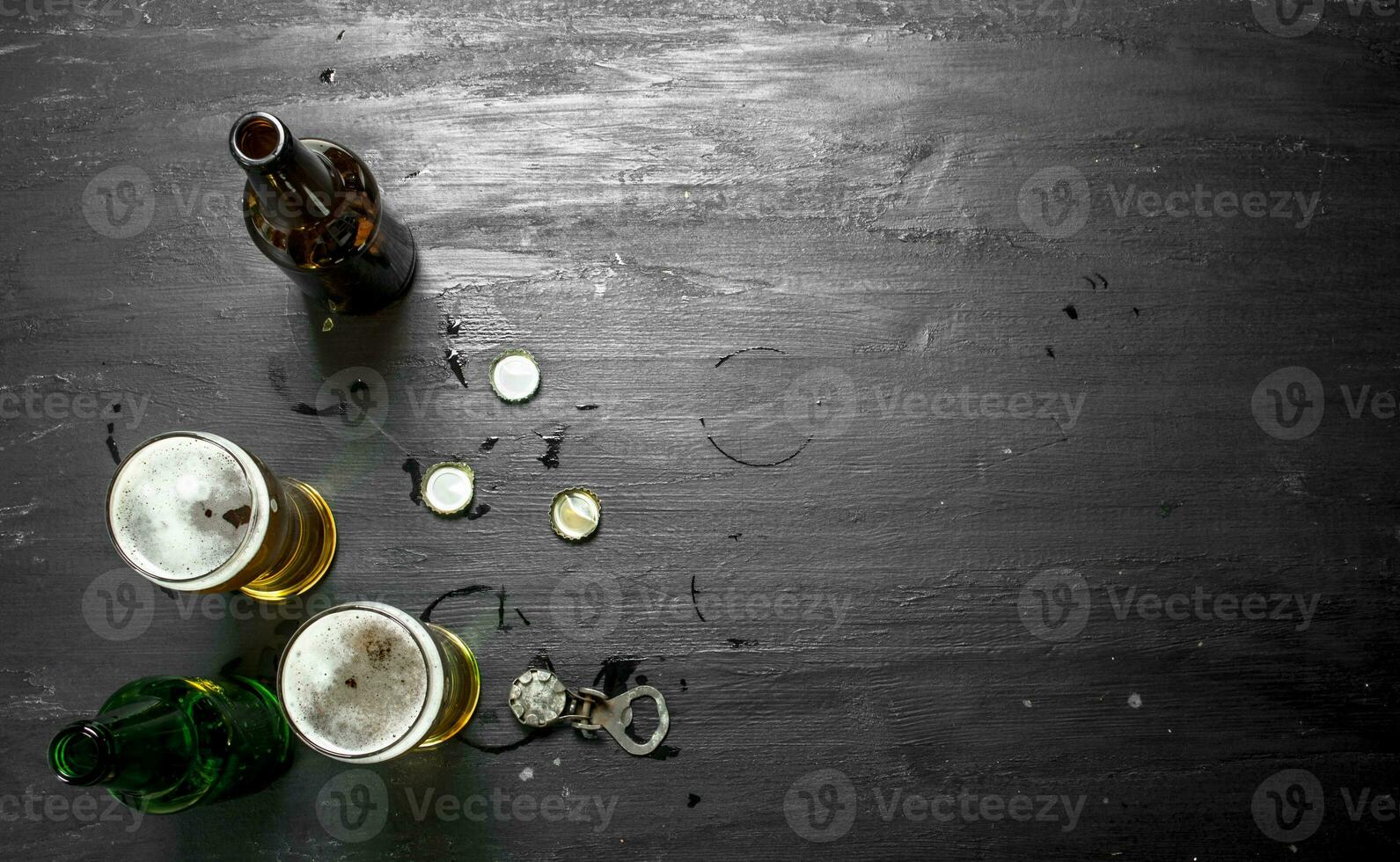 Glasses with beer, stoppers and opener. photo