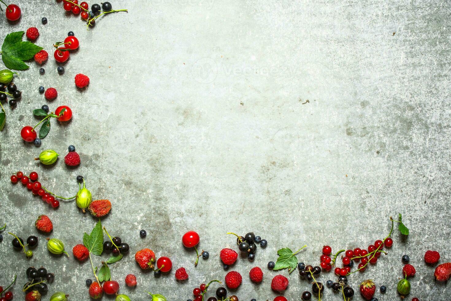 Different berries on the stone table. photo