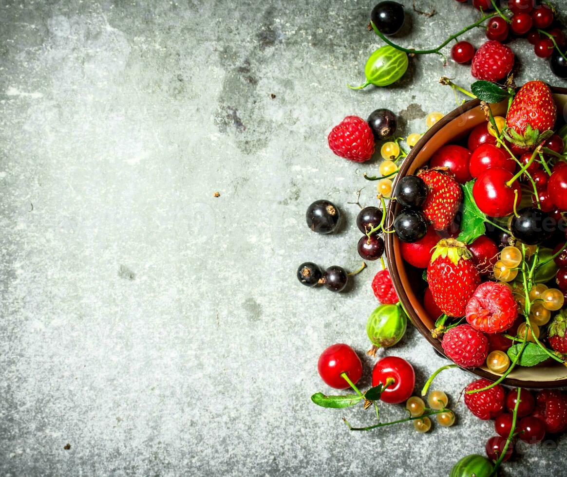 Berries in a Cup. On stone table. photo