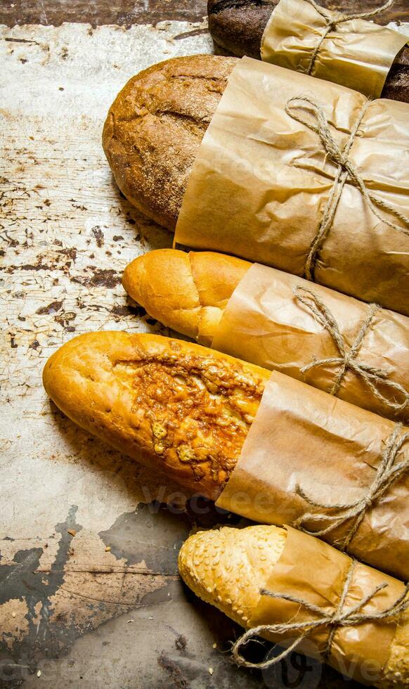 Set fresh bread on rustic background. photo