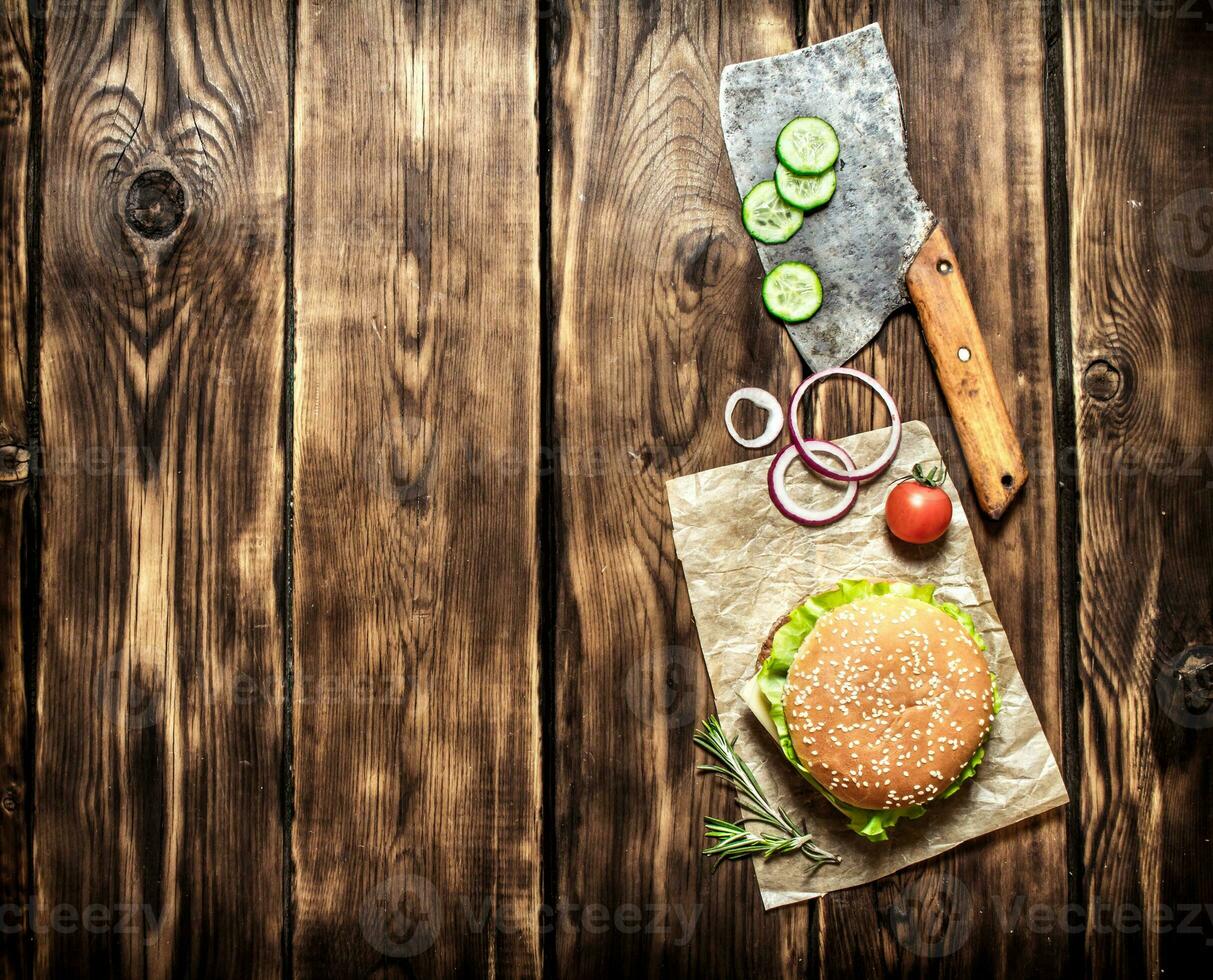 Cooked Burger with vegetables, cheese and meat. photo