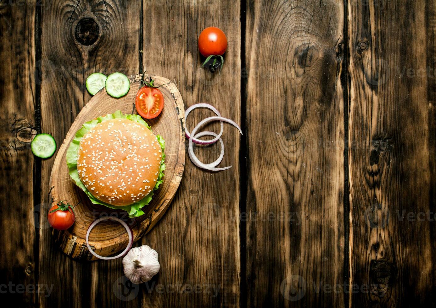 Cooked Burger with vegetables, cheese and meat. photo