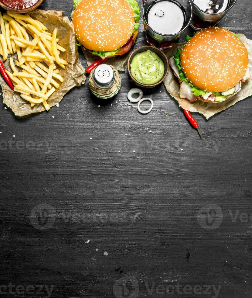 Fast food. Burgers with fries and cola. photo