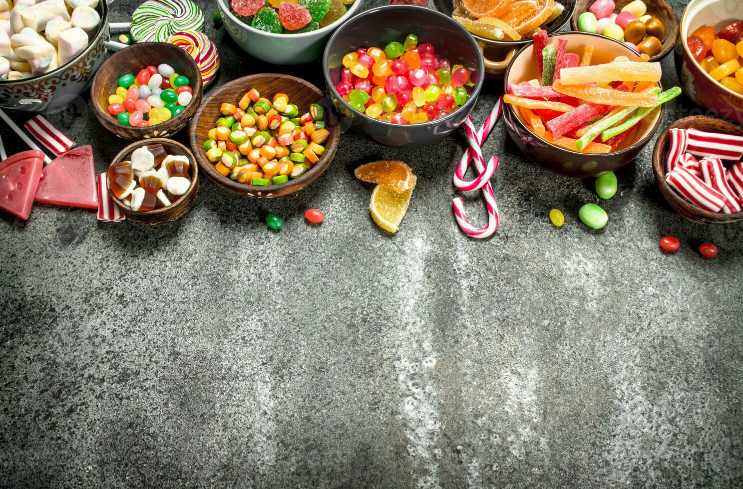 Multicolored candy, jelly and marshmallows in a bowl. photo