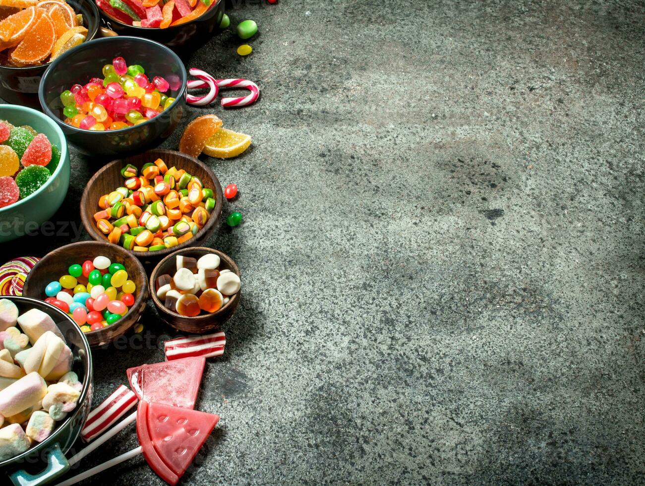 Multicolored candy, jelly and marshmallows in a bowl. photo