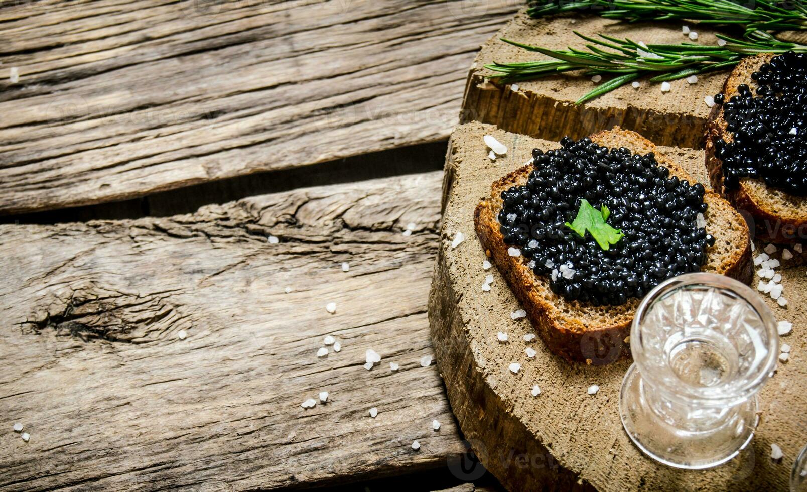 Sandwiches with black caviar and vodka. photo