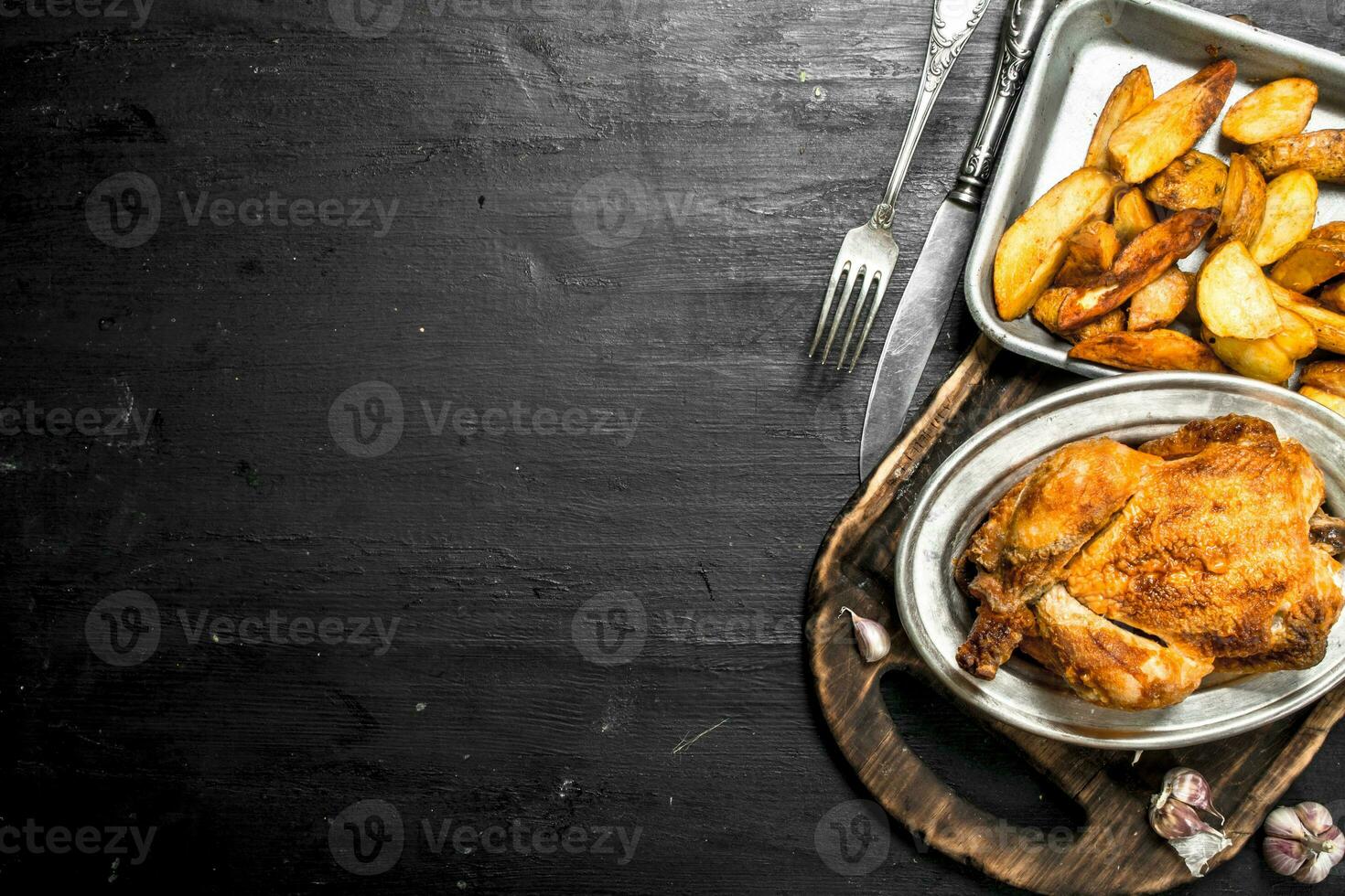 Fried chicken with potatoes on a tray. photo