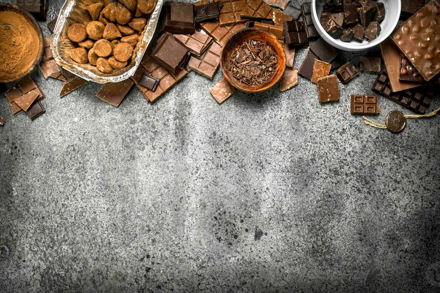 Different kinds of chocolate in bowls. photo