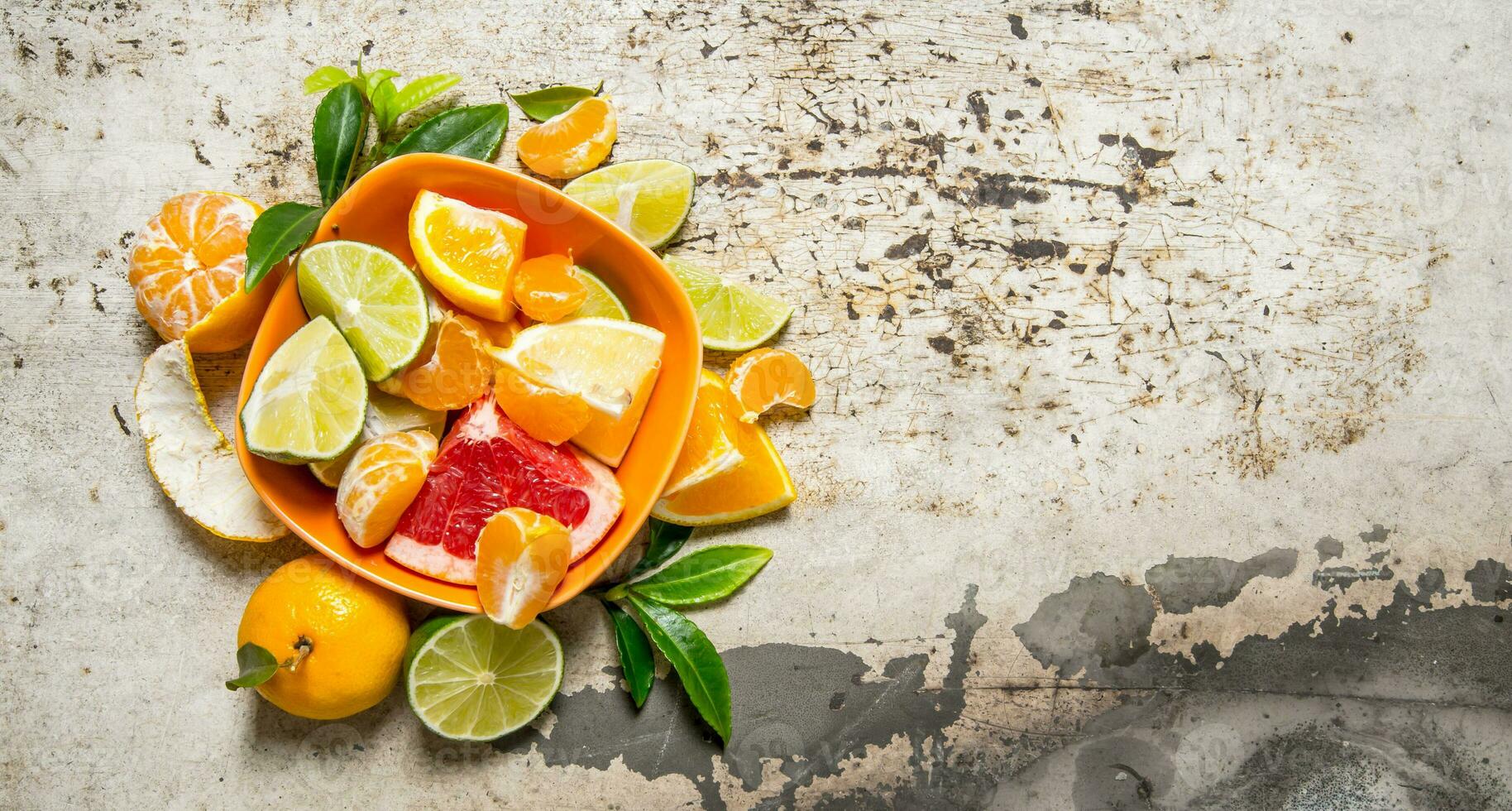 Sliced citrus - grapefruit, orange, tangerine, lemon, lime in the Cup. photo