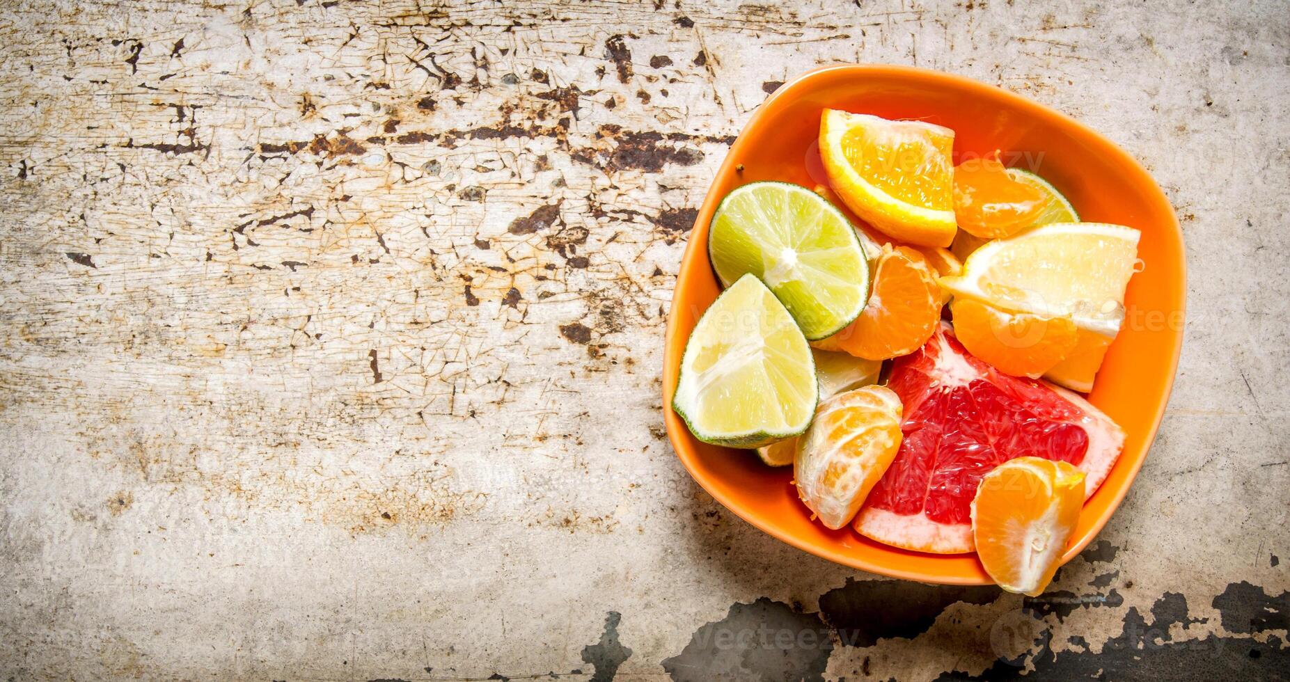 Sliced citrus - grapefruit, orange, tangerine, lemon, lime in the Cup. photo
