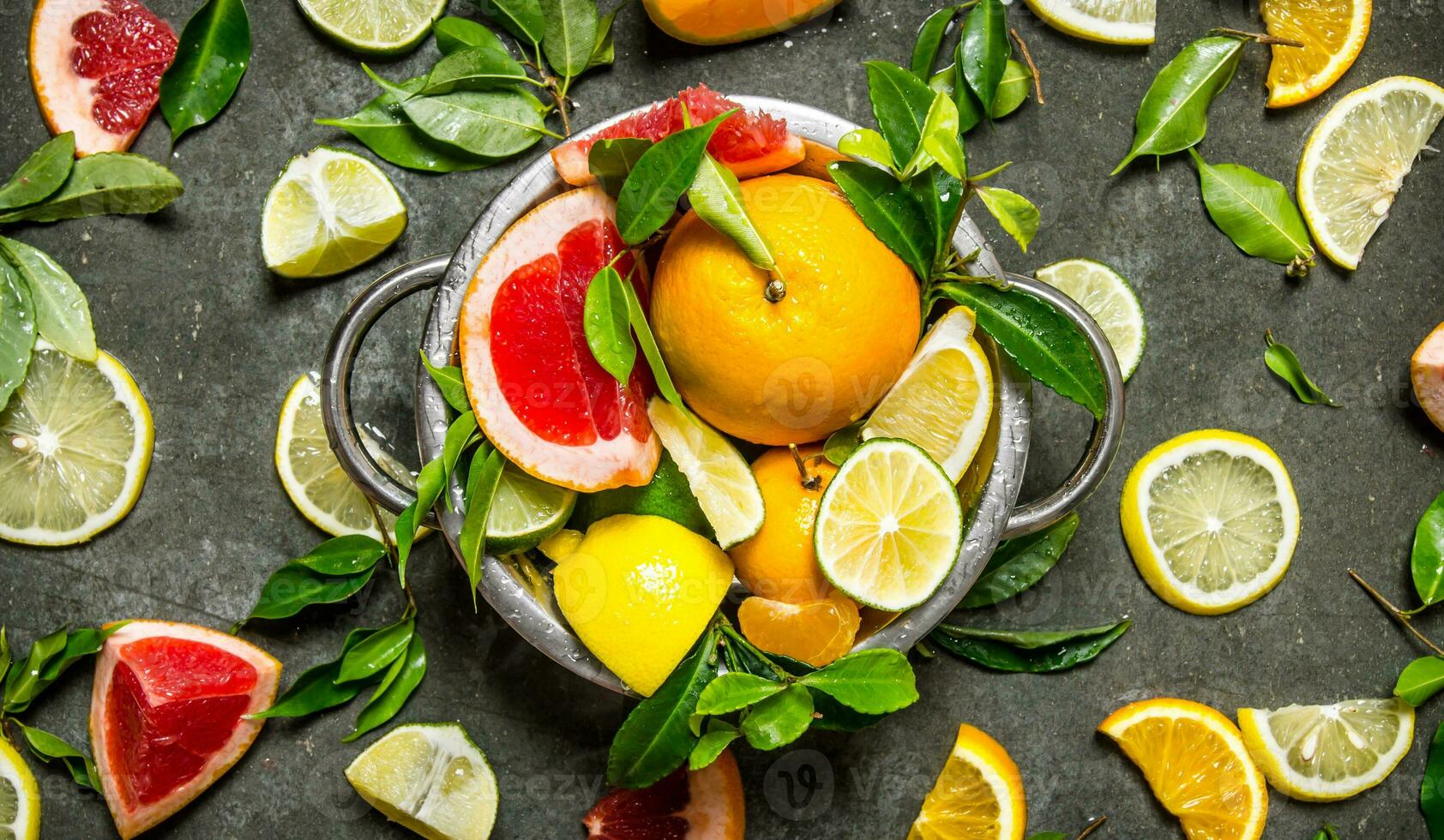 Citrus fruits - grapefruit, orange, tangerine, lemon, lime in a cup. photo