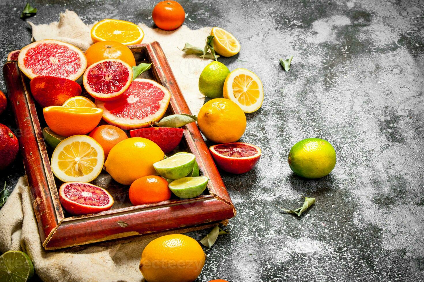 Citrus background. Citrus fruits in the old tray. photo