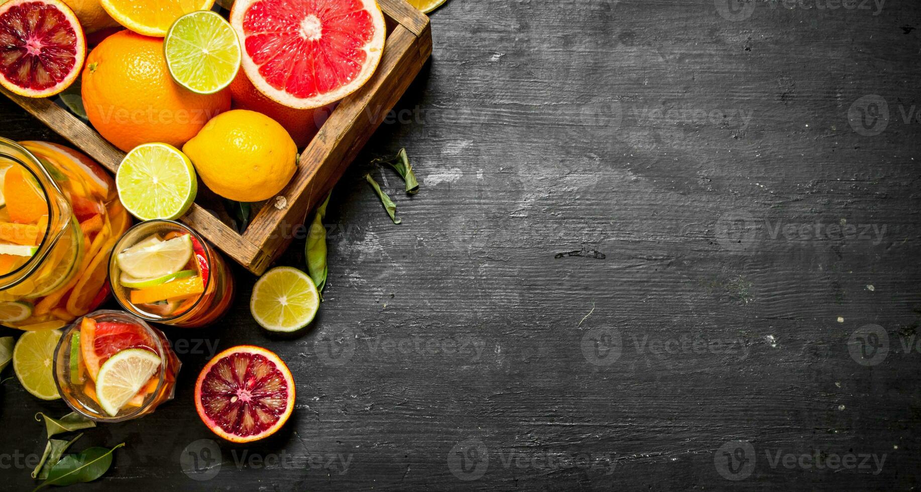 Citrus background. Fresh citrus juice with slices of limes, oranges, grapefruits and lemons. photo