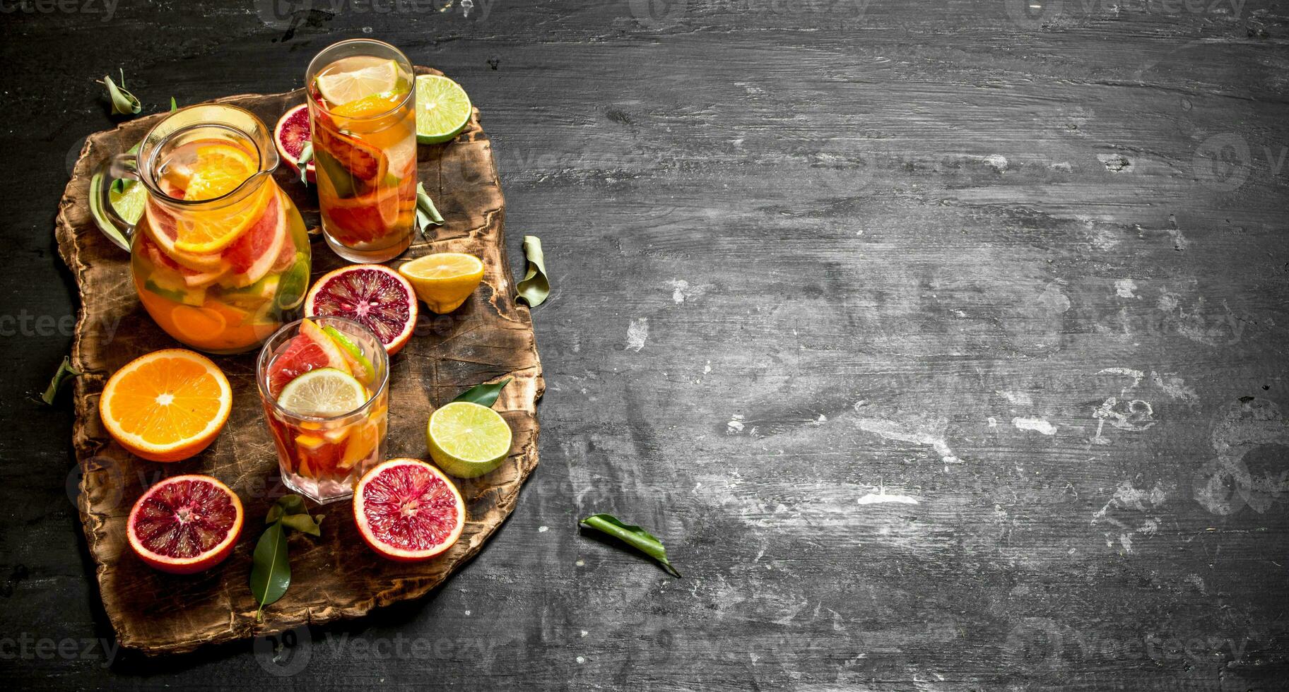 Citrus background. Fresh citrus juice with slices of limes, oranges, grapefruits and lemons. photo