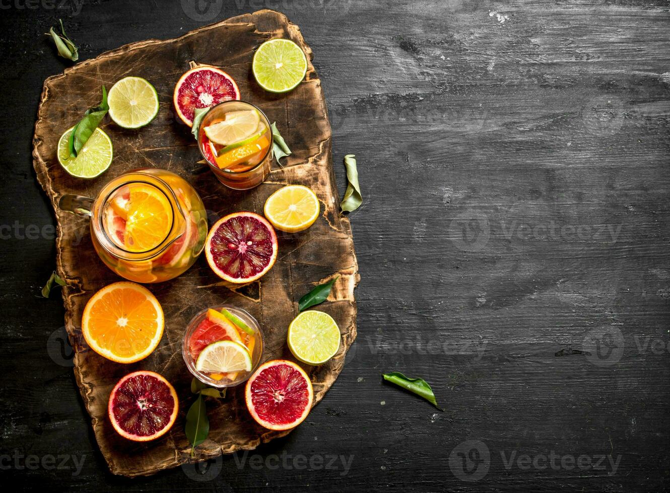 Citrus background. Fresh citrus juice with slices of limes, oranges, grapefruits and lemons. photo