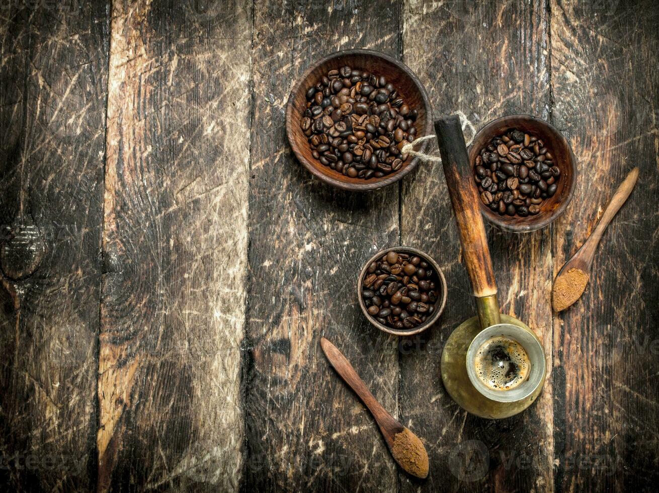 Coffee background. Freshly brewed coffee with grains in a bowl. photo