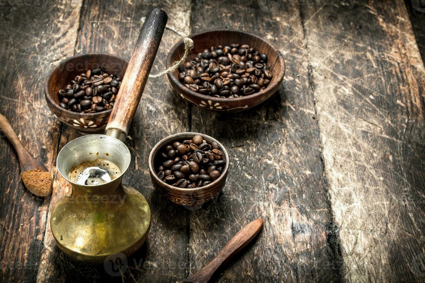 Coffee background. Freshly brewed coffee with grains in a bowl. photo