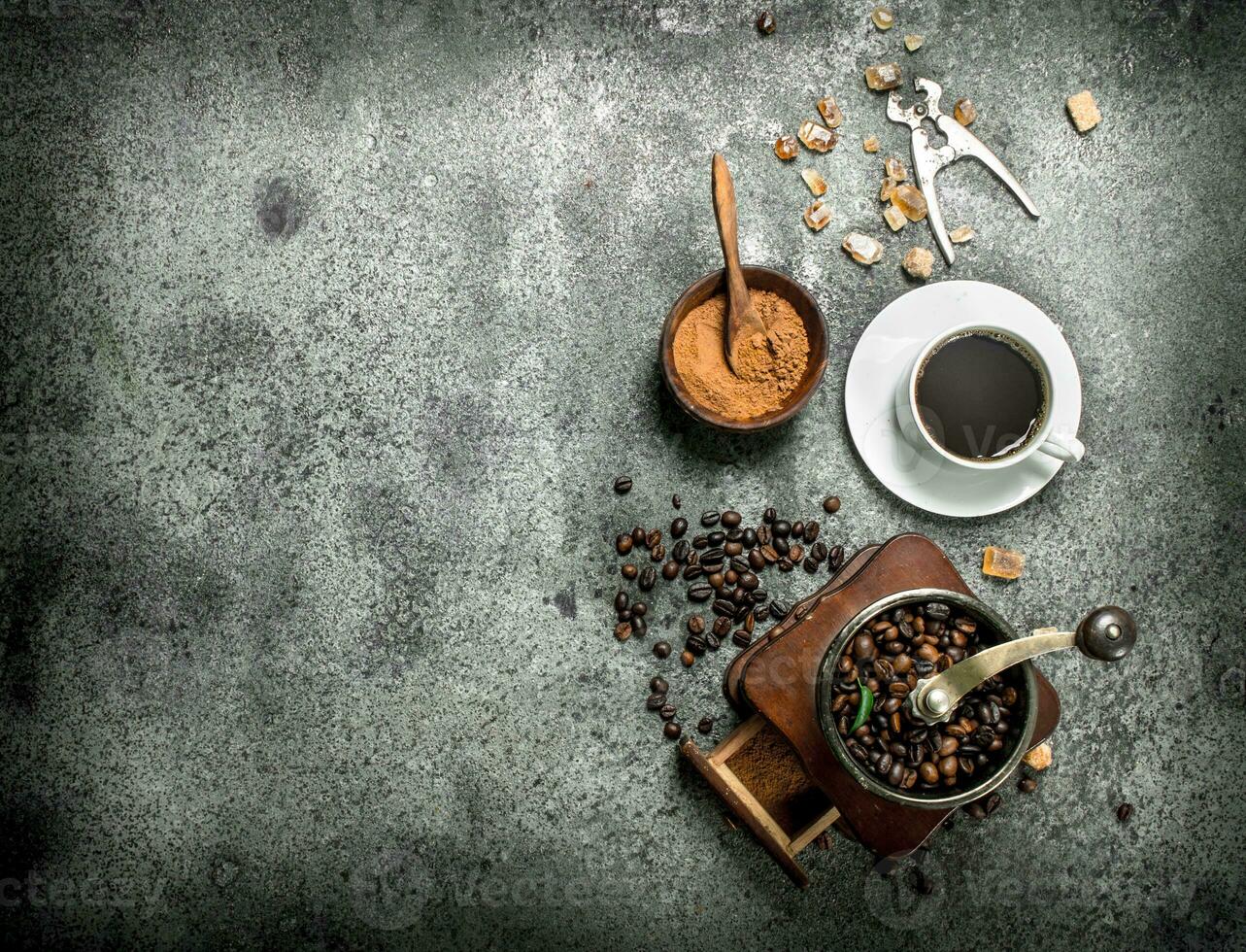 Fresh coffee with in a cup with a coffee grinder. photo
