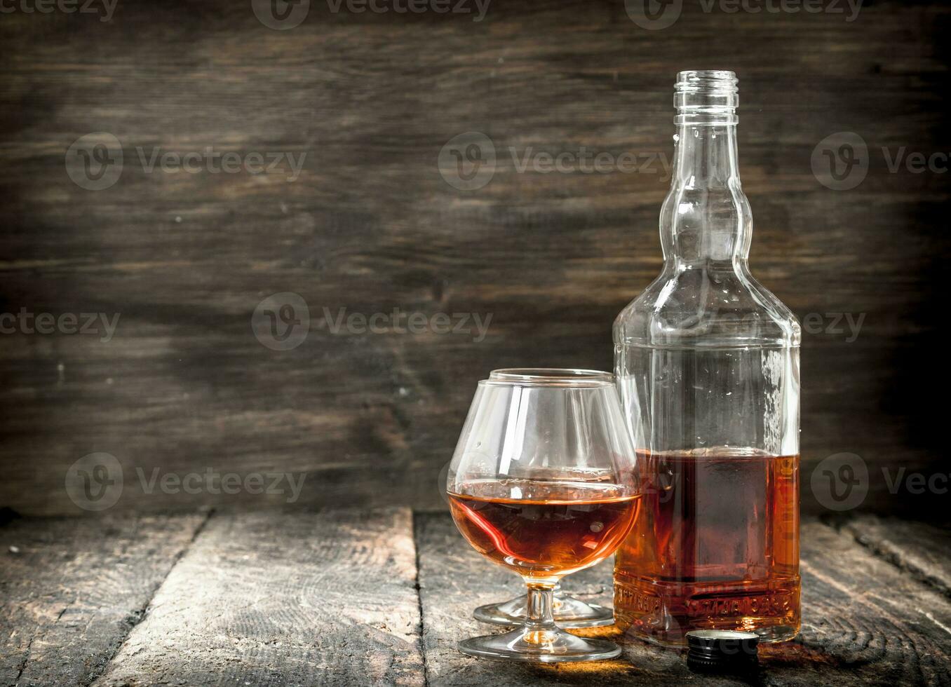 French cognac in a bottle with glasses. photo