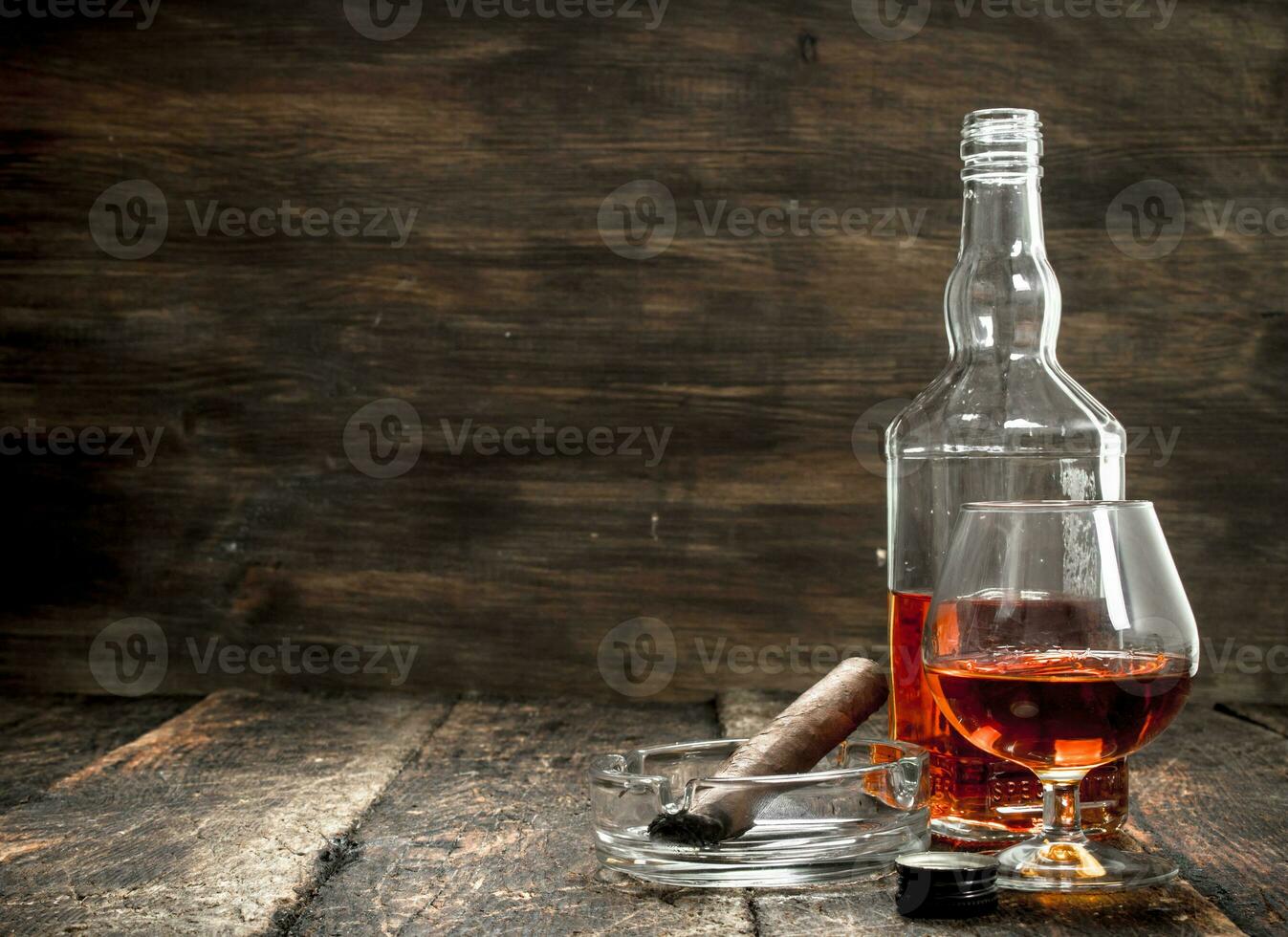 French cognac with a smoking cigar. photo